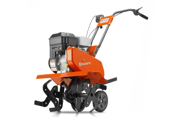 Side view of a Husqvarna tiller with visible engine and rotary blades.