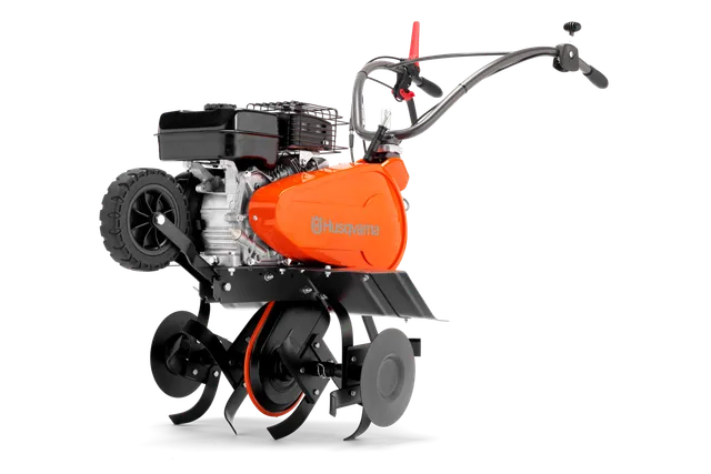 Side view of a Husqvarna tiller with visible engine and tines.
