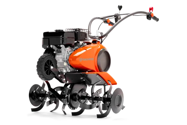 Seitenansicht einer Husqvarna Motorhacke mit sichtbarem Motor und Zinken.