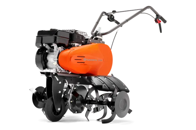 Vue latérale d’un motoculteur Husqvarna avec moteur et poignée visibles.