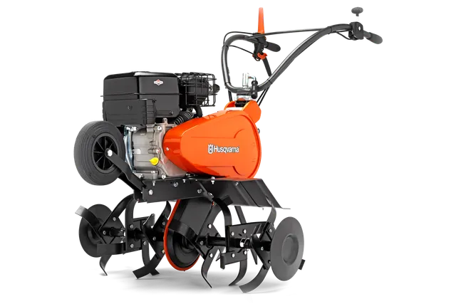 Side view of a Husqvarna rotary tiller showcasing its engine and tines.