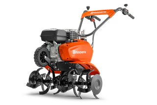 Side view of a Husqvarna tiller showcasing its blades and engine.