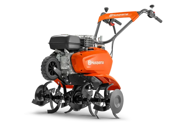 Vue latérale d’un motoculteur Husqvarna présentant ses lames et son moteur.