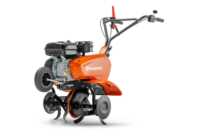 Seitenansicht einer Husqvarna Motorhacke mit sichtbarem Motor und Klingen.