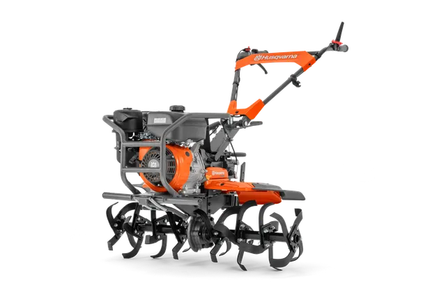 Side view of a Husqvarna tiller with visible tines and engine.