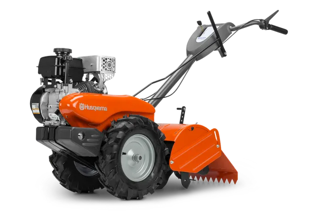 Side view of a Husqvarna garden tiller with visible engine and control handles.