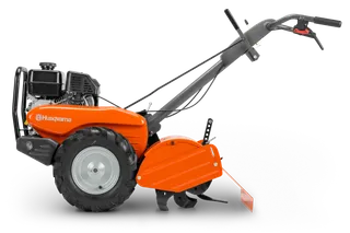 HUSQVARNA TR 430. Vista lateral de una motoazada Husqvarna con el motor y los mangos de control visibles.