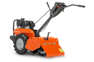 HUSQVARNA TR 430. Vista lateral de una motoazada Husqvarna con el motor y los mangos de control visibles.