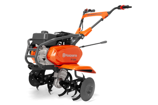 Side view of a Husqvarna TF 230 tiller showcasing its blades and handle.