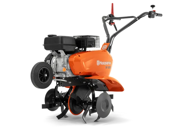 Husqvarna TF 325. Seitenansicht einer Husqvarna TF 325 Motorhacke mit Motor und Messern.