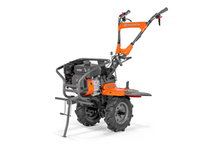 Вид збоку на культиватор Husqvarna з міцними колесами й ергономічними рукоятками.