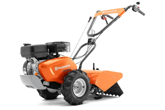 Boční pohled na kultivátor Husqvarna s robustními koly a motorem.