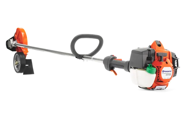 Side view of a Husqvarna brushcutter with ergonomic handle and cutting blade.