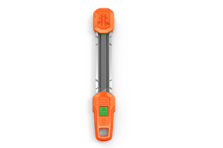 Top view of a tool with measurement markings and an orange protective cover.