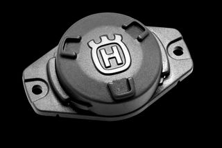 Top view of a Husqvarna accessory with a branded emblem, designed for attachment.