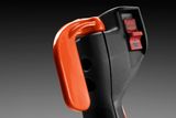 Close-up of a control handle with a stop button and an orange lever.