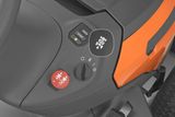 Close-up view of a control panel on a ride-on mower, showing various operational buttons.
