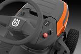 Close-up view of the control panel and steering wheel of a Husqvarna ride-on mower.