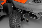 Close-up view of a ride-on mower's suspension and wheel.