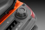Close-up of a fuel cap and control panel on a ride-on mower.