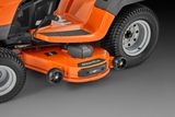 Close-up of a ride-on mower's cutting deck and wheels.