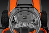 Top view of a ride-on mower's steering wheel and control panel.