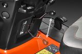 Close-up of a ride-on mower's control levers and foot pedal.