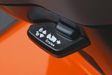 Close-up of a cruise control lever on a lawn mower.