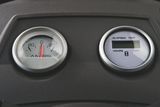 Close-up view of two gauges, one showing amperes and the other displaying elapsed time in hours.