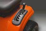 Close-up of a ride-on mower's gear shift lever and control panel.