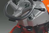 Close-up view of a Husqvarna ride-on mower's steering wheel and control panel.