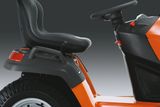 Side view of a ride-on mower seat and steering wheel.