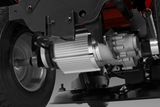 Close-up view of a mechanical component under a ride-on mower, showcasing the transmission system.