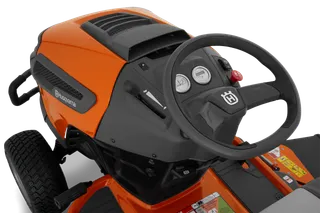 Close-up view of the control panel and steering wheel of a Husqvarna ride-on mower.