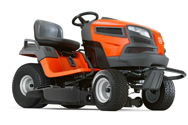 Side view of a Husqvarna ride-on lawn mower with visible cutting deck.