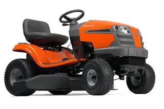 Side view of a Husqvarna ride-on lawn mower with visible steering wheel and seat.