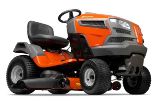Husqvarna YTH1942. Side view of a Husqvarna ride-on lawn mower with cutting deck.