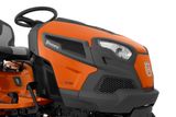 Side view of a Husqvarna ride-on mower showcasing its design and steering wheel.