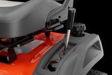 Close-up of a ride-on mower seat and rear wheel, showcasing design details.