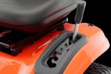 Close-up of a ride-on mower seat and control lever.