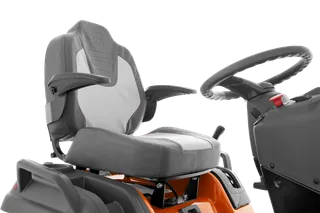 Close-up view of a Husqvarna ride-on mower seat and steering wheel.