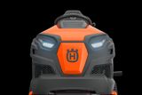 Front view of a ride-on mower with a steering wheel and headlights.