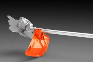 Side view of a grass trimmer head with protective shield.