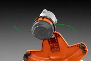 Close-up view of a trimmer head with dual cutting lines.