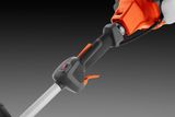 Close-up view of a trimmer handle with ergonomic grip and control switches.