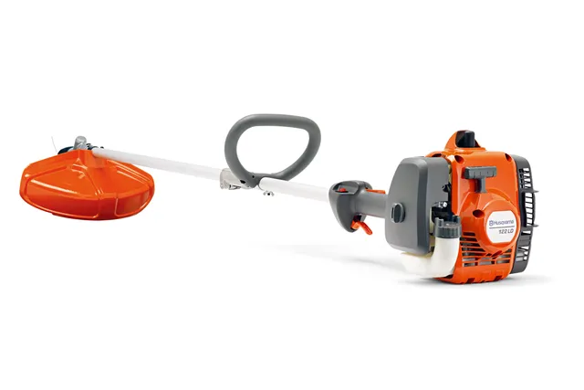 Side view of a Husqvarna brush cutter with a visible engine and cutting head.
