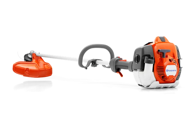 Side view of a Husqvarna brush cutter with ergonomic handle and cutting head.
