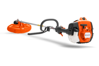 Side view of a Husqvarna brush cutter with ergonomic handle and cutting blade.