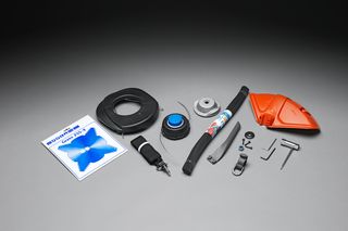 Top view of various gardening accessories including trimmer line, blade, and protective cover.
