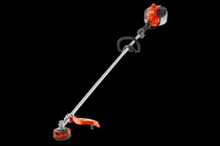 Side view of a grass trimmer with a loop handle and cutting head.